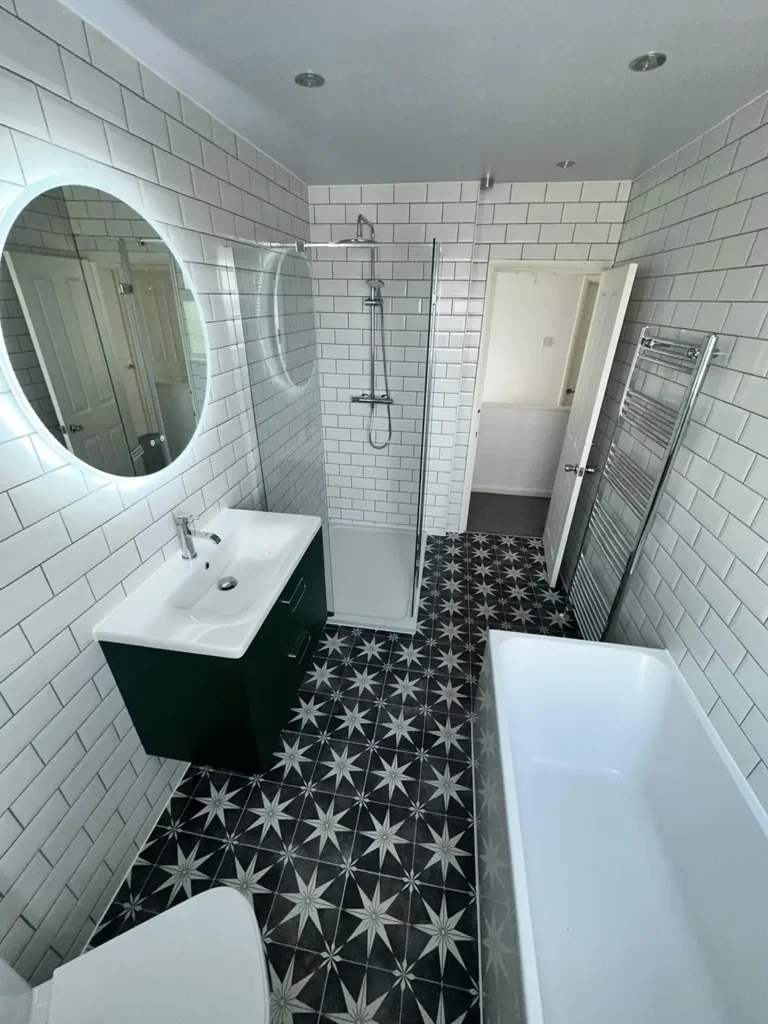 Modern bathroom with walk-in shower, freestanding bath, vanity unit and patterned floor tiles